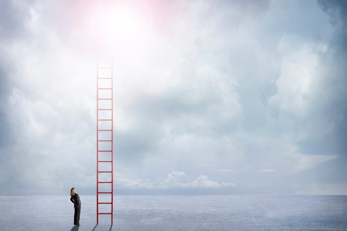 Businesswoman Looks Up At Red Ladder Extending Into The Clouds