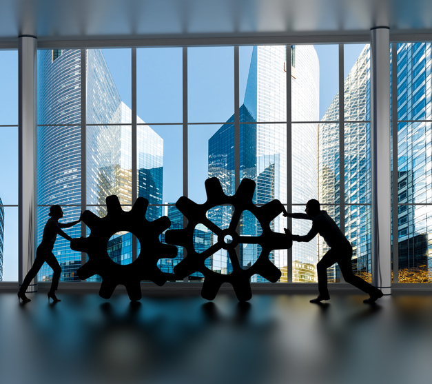 Business collaboration concept Silhouettes of business partners moving gears inside an office